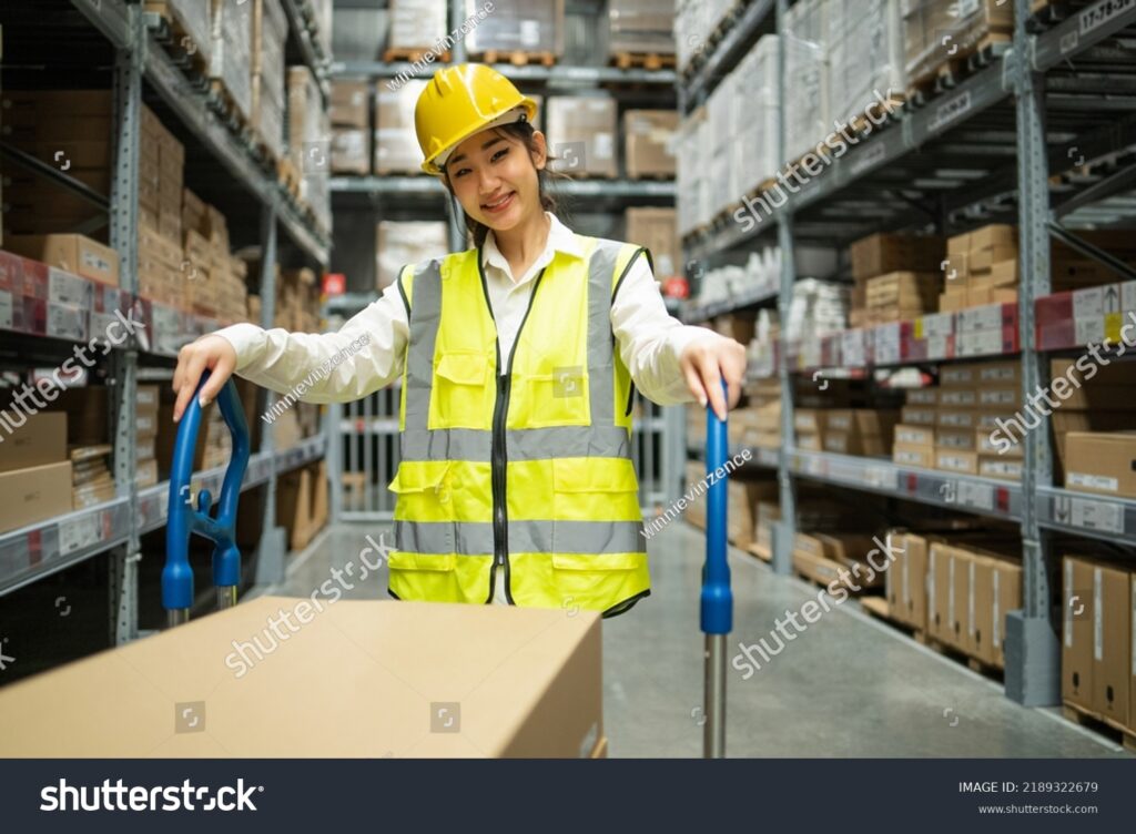 stock photo portrait of asian female warehouse worker with trolley smile to camera at the distribution center 2189322679 (1)