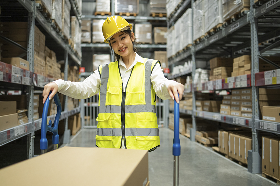 portrait,of,asian,female,warehouse,worker,with,trolley,smile,to